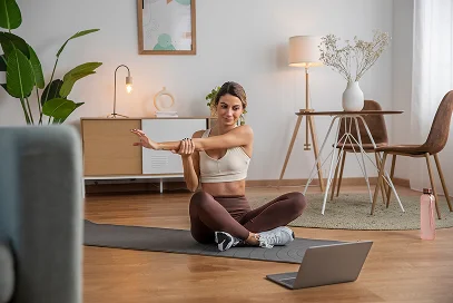 female-fitness-instructor-using-laptop-teach-class-from-home